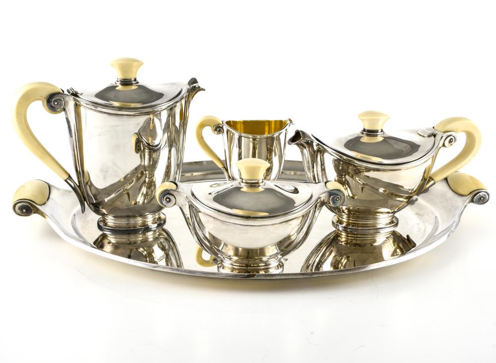 MARCEL WOLFERS (1886-1976) FOR WOLFERS FRÈRES: Marcel Wolfers (1886-1976) for Wolfers Frères"Méda" tea and coffee set, designed in 1935Silver and ivory, composed of a platter, a tea pot, a coffee pot, a sugar bowl and a creamer. Hallmark