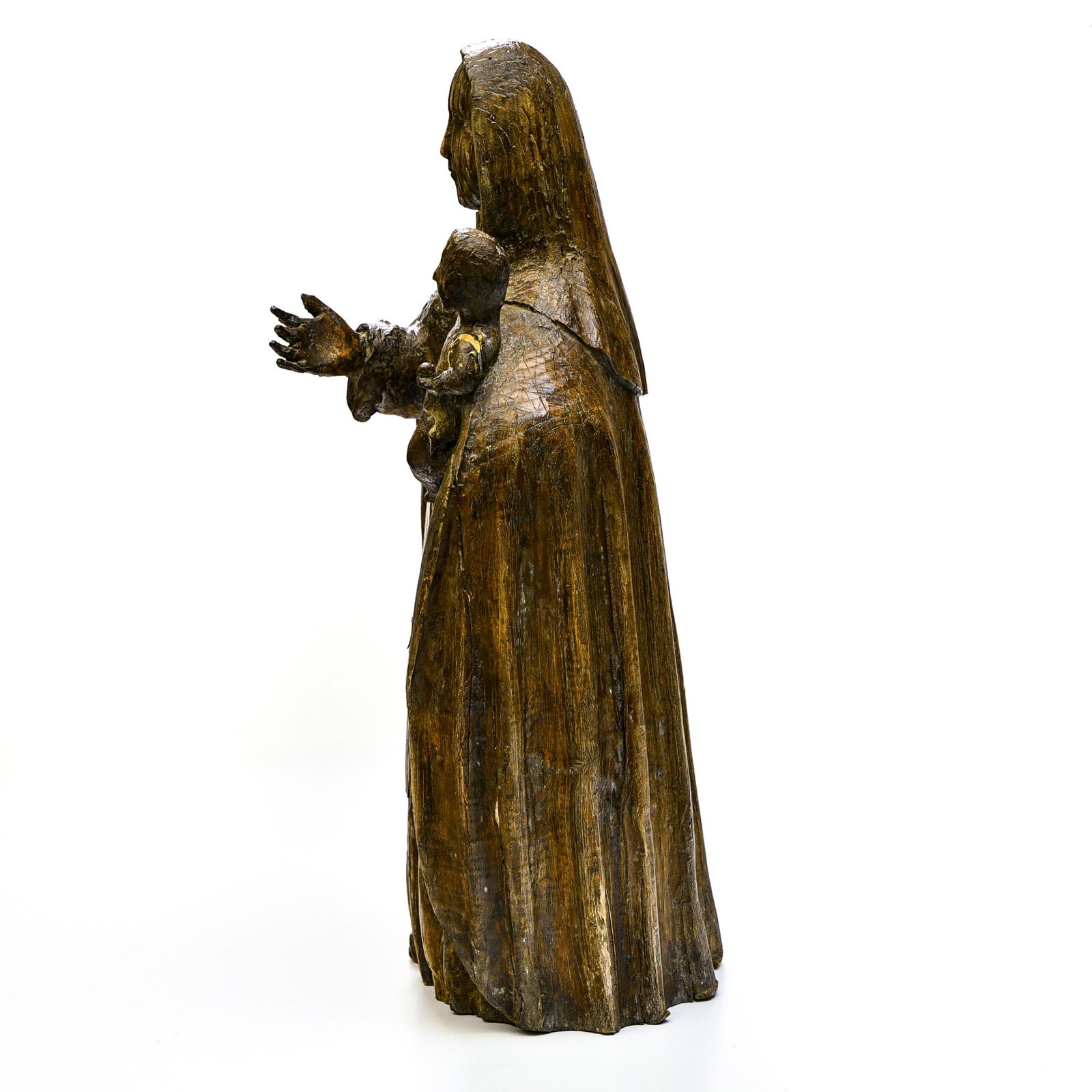 Madonna and Child: Madonna and Child15TH CENTURYRonde-bosse carved wood. Mary is standing, holding the Child in her left arm; she wears a robe with a surplice and a veil forming a cloak surrounding her head.Expert: Cabi