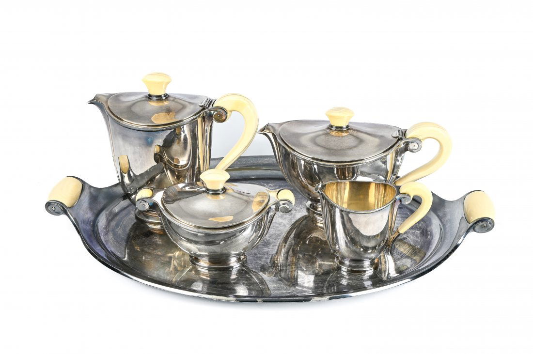 MARCEL WOLFERS (1886-1976) FOR WOLFERS FRÃˆRES: Marcel Wolfers (1886-1976) for WOLFERS FrÃ¨resMÃ©da' tea and coffee set, designed in 1935silver and ivory, composed of a platter, a teapot, a coffee pot, a sugar bowl, and a creamer. Hallmarks und