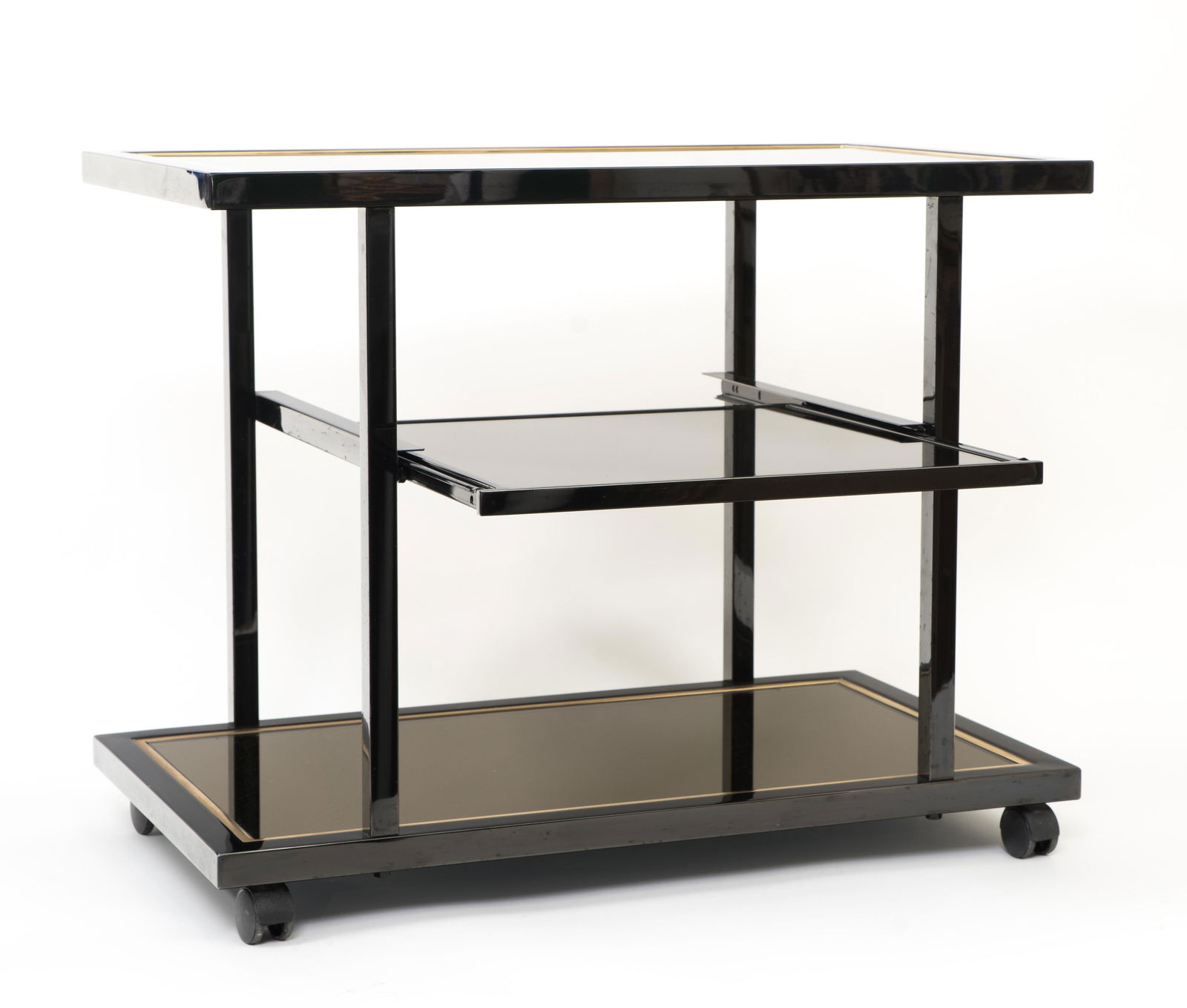 ROGER VANHEVEL: Roger VanhevelBar cart on wheels, ca. 1970Black-lacquered metal brushed with gold (23 carats), mirrored surface and tinted glass. Sliding central surface. Original tag. H : 63 cm Width : 47 cm Depth :