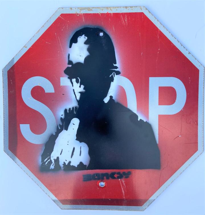 Banksy Spray paint over original stop sign (1 of 3)