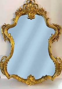 Antique French Louis XV or Rococo Gold Gilt Mirror: Private Collection Carved Wood Almost 5 Feet x 3.5 Feet Large Antique French Louis Quinze or Rococo Style Gold Gilt Mirror with Facetted Glass . This beautiful abundant ornamented French mirror was