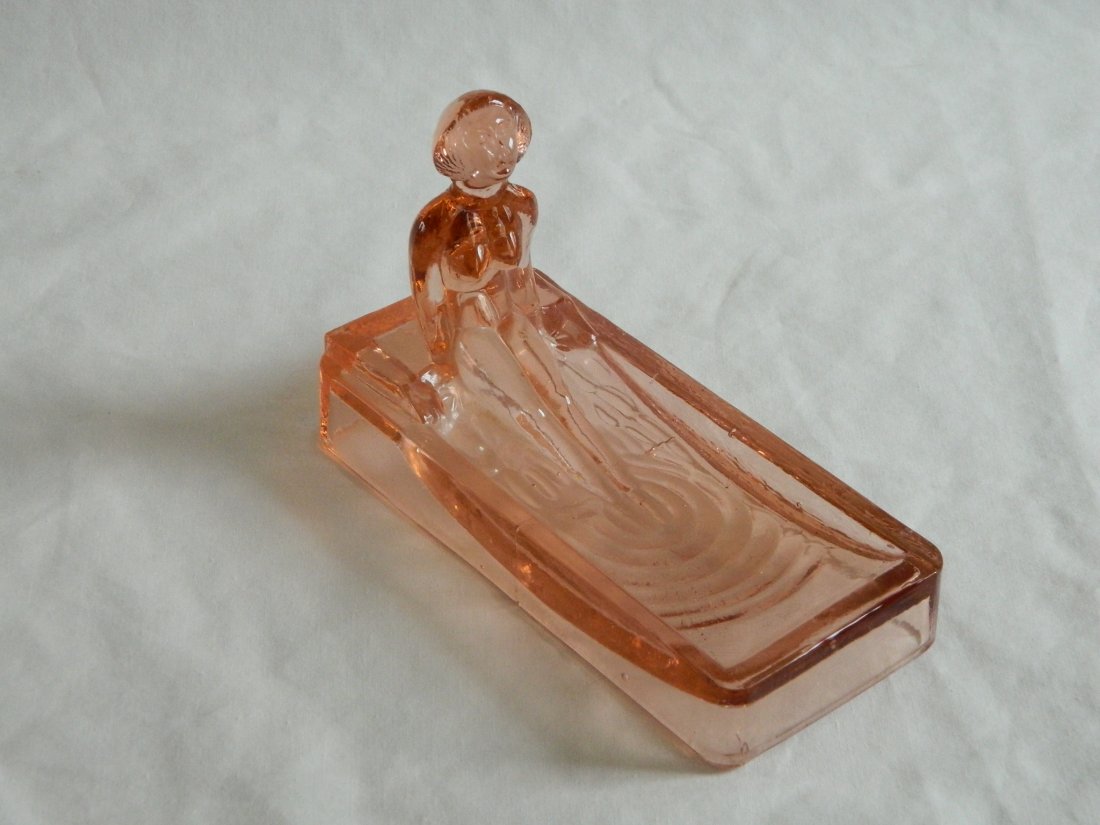 Pink depression glass nude lady soap dish: Pink depression glass soap dish in the form of a nude lady with her feet soaking in the tub. Measures 6" x 2 3/4" x 4" tall to the top of her head.