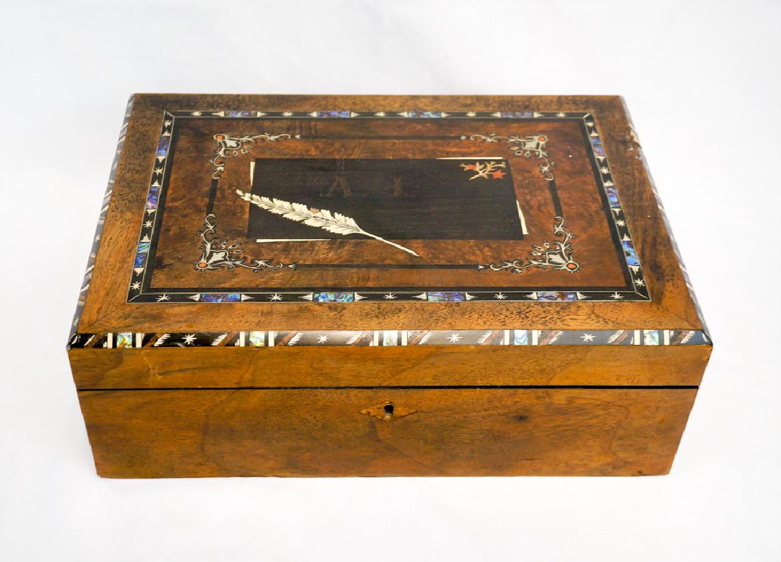 An Antique Lap Desk with Inlaid Abalone: An antique lap desk with inlaid abalone. Measures 14 7/8" x 10 3/8" x 5 3/8" In good condition with some inlay loss in areas. Includes key and key cover. Lock functions properly. We ship most items in