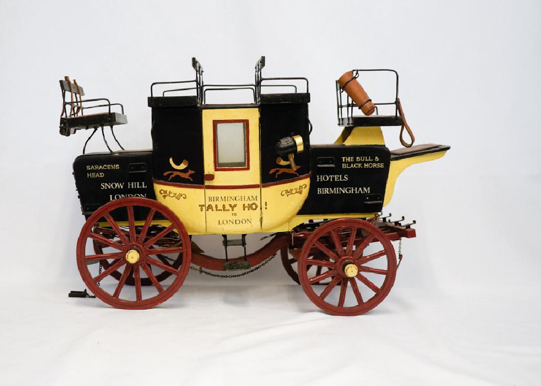 Large English Stage Coach Model: A large English stage coach model measuring 18" in length. There is wear on the covering of the top center seat and the wood slat connecting the axel is split. We ship most items in house. Exclusions 