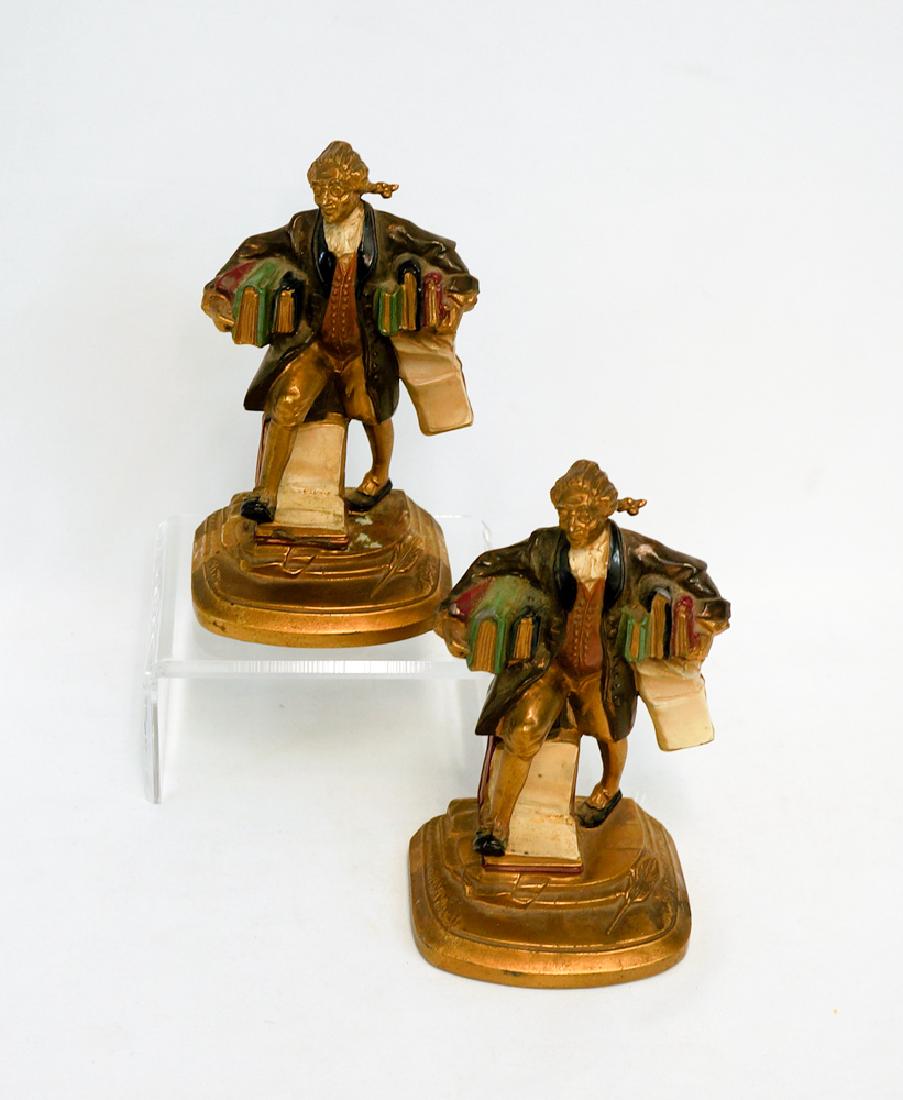 Pair Figural Bookends: A pair of vintage figural bookends. Painted metal filled pieces, likely spelter or armored bronze. Measure 6 3/8" tall. They have paint loss and tape residue, overall fair to good condition. We ship m
