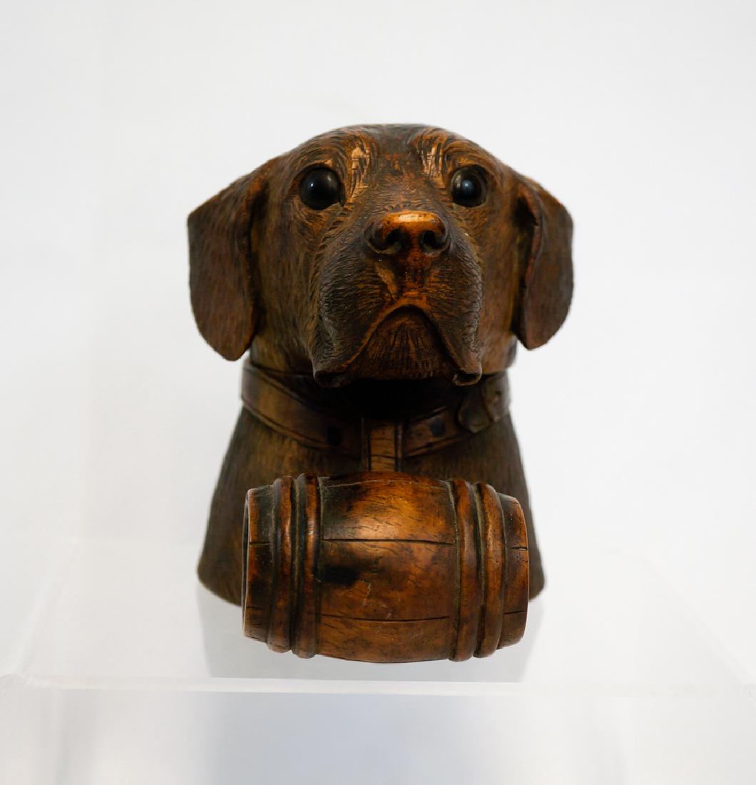 Black Forest Carved Dog's Head Inkwell: Black Forest style carved inkwell in the form of a dog's head, glass eyes, with St. Bernard style barrel. Measures 4.25" x 3.25" x 4.25". We ship most items in house. Exclusions include furniture, ove
