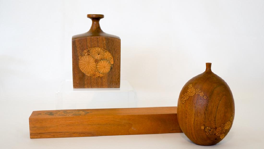 Roger Sloan Wood Vases and Incense: Three pieces by Roger Sloan. Includes a weed pot measuring 4.75" x 3", a vase measuring 5" x 3.25" x 2.5" and a bud vase or incense holder measuring 11.75" in length. Vase and incense in excellent con