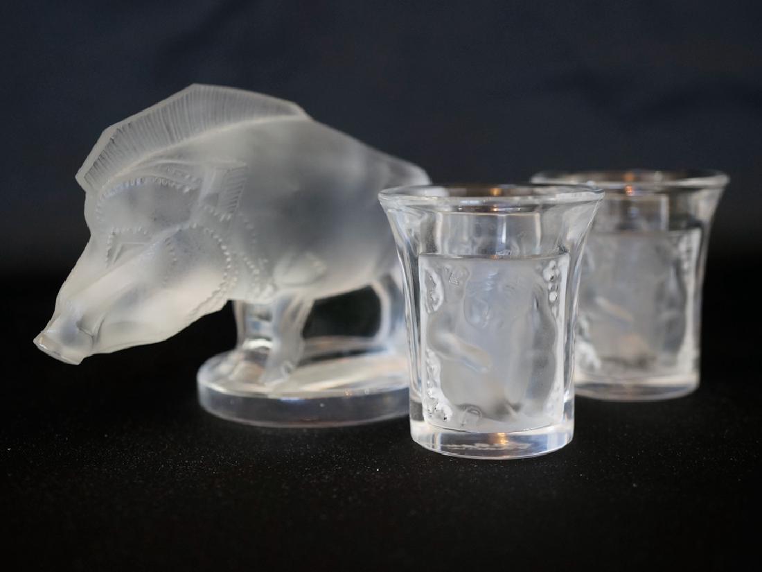 Lalique Boar Figure and Shot Glasses: Lalique Boar figure measuring 2.75" x 3.5" and two Les Enfant shot glasses measuring 1.75" x 1.5". All are in excellent condition with no cracks, chips or repairs. We ship most items in house. Exclusi