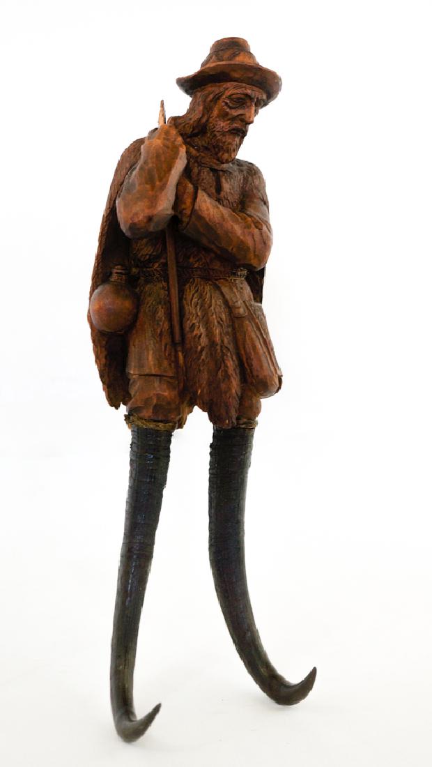 Black Forest Carved Coat Hook: Black forest carved coat hook. Measures 12" x 3.25" x 3.25" (30.5 cm x 8.25 cm x 8.25 cm). Has a break to the top of his walking stick or cane. No other damage. We ship most items in house. Exclusions