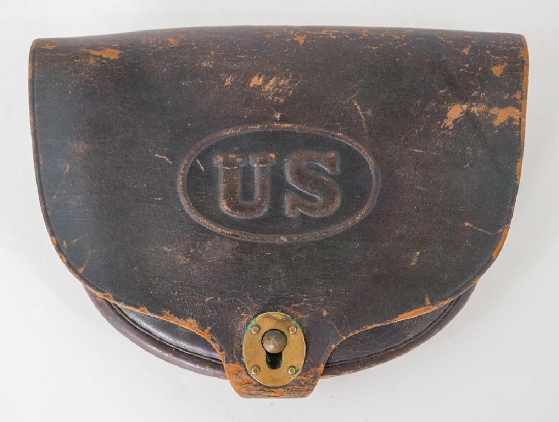 U.S. Musket Cap Pouch Rock Island Arsenal: [Civil War, Militaria, Rock Island Arsenal] U.S. Musket Cap Pouch, black leather with embossed U.S. Stamped Rock Island Arsenal on backside and has the initials W.L.F. and W.P. stamped on straps of ba