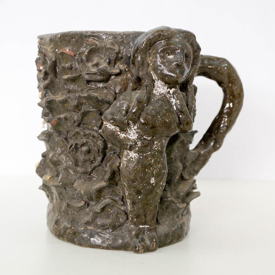 A Large Folk Art Handled Tankard Wallula, Wa.: A large folk art handled tankard or mug. Tag inside reads "Found down by Wallula before McNary Dam". Measures 7.5" x 8". Drilled base, unsigned. Chips, other imperfections. We ship most items in-house