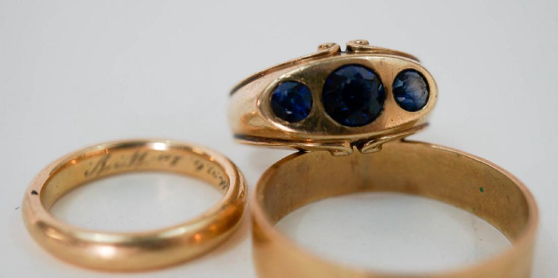 Three Gold Rings Two 14k Gold Bands and One 10k: Three gold rings including two 14k gold bands weighing 11 grams and a 10k gold ring with stones or simulated stones weighing 6.4 grams. We ship most items in-house with the exception of firearms, larg