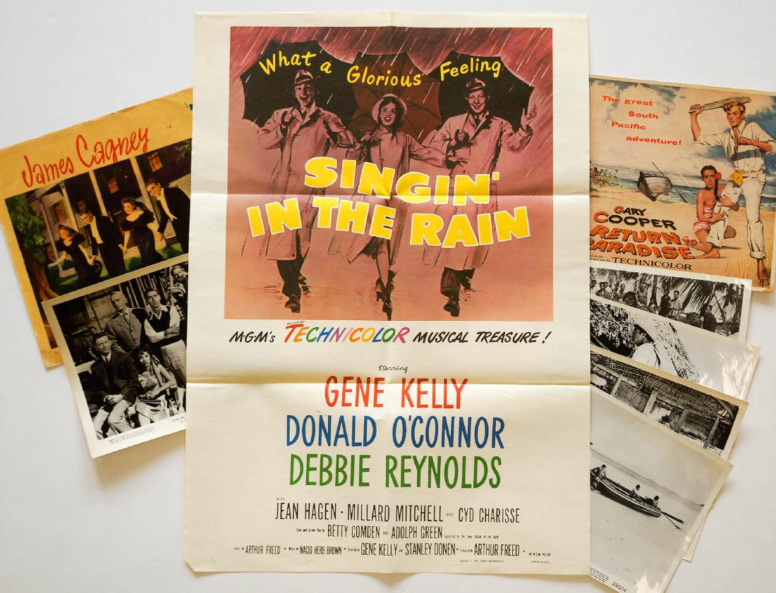 Group of Movie Posters Singin' in the Rain +: Includes Singin' in the Rain and Return to Paradise. 1 8"x10" b/w photo of Singin in the Rain scene, 1 color poster Singin in the Rain 27" x 19 1/4", 1 James Cagney in Yankee Doodle Dandee color poste