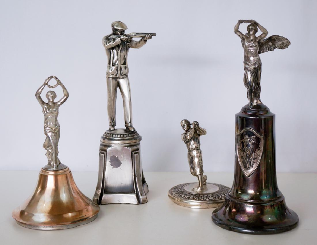 Group of Vintage Silver Plate Sporting Trophies: Group of vintage silver plate sporting trophies. Measure 4.5" to 10". Golfer trophy is missing club head. Golfer and smaller woman are trophy cup lids, other two are complete. We ship most items in-ho