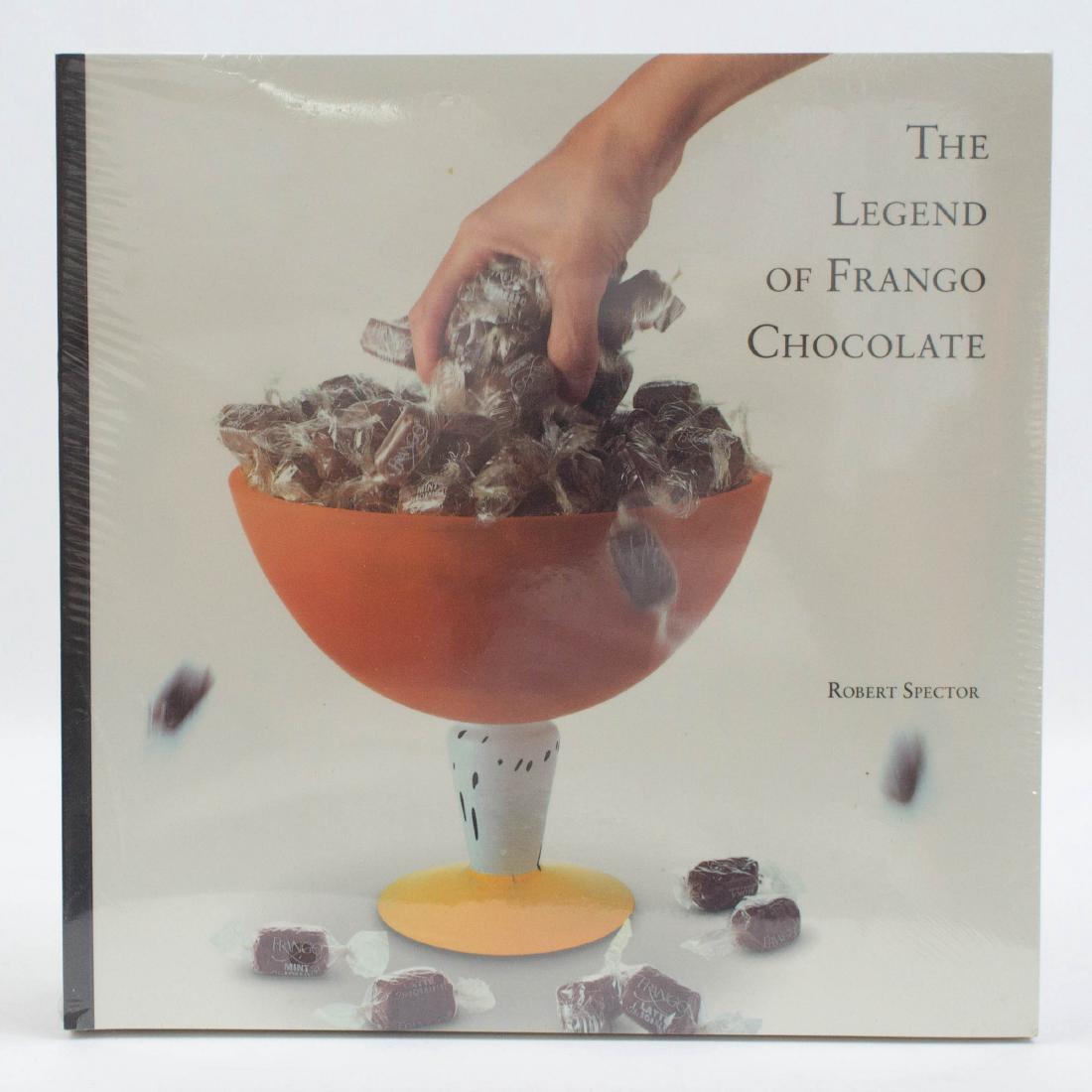 The Legend of Frango Chocolate (Lot of 12): The Legend of Frango Chocolate by Robert Spector. Lot of 12 factory-sealed. Documentary Book Publishers Corporation, Kirkland, WA. Provenance: Estate of Russell Johanson, Ravenna Rare Books. We gladly