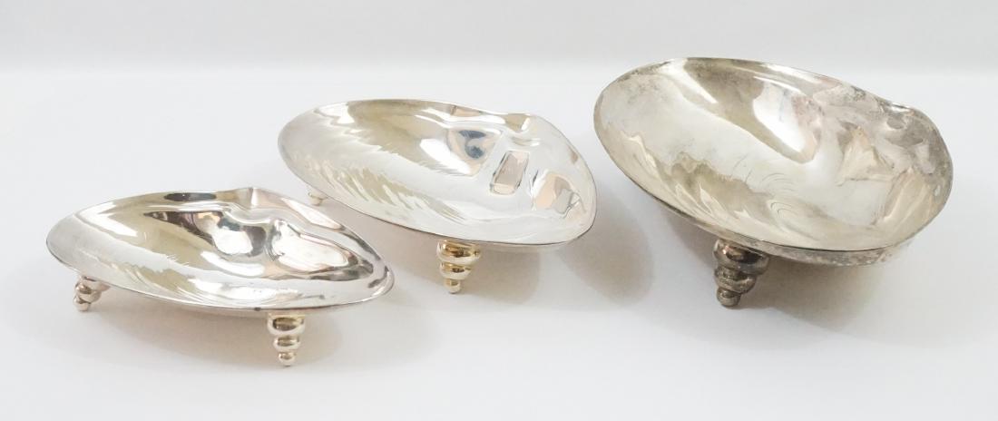 A Set of Designer Nesting Silver Plate Shell Bowls: A fine set of silver plate nesting shell bowls. Silver plate, unmarked and measure 3.75" x 8.5" x 12.25" when nesting as a group. We ship most items in this auction in-house with the exception of furn