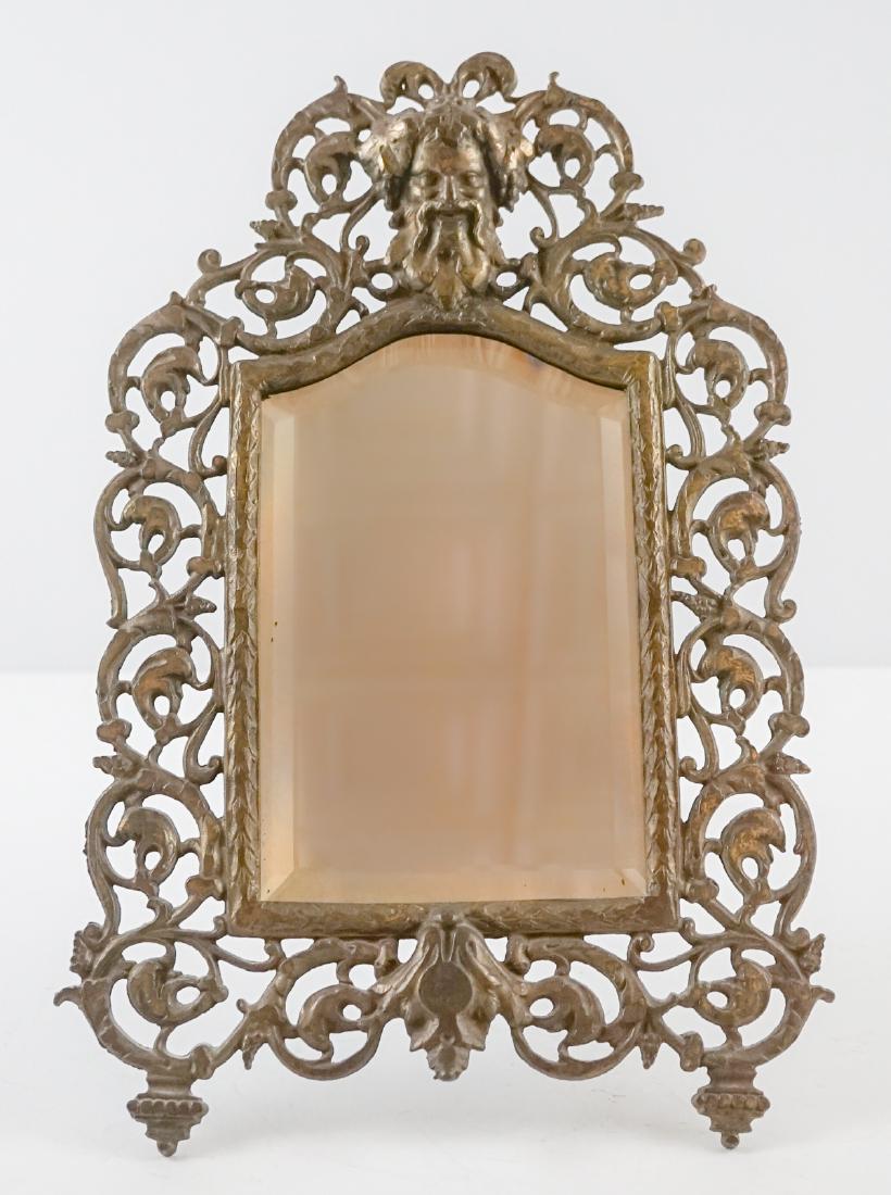 An Antique Easel-Back Mirror: An antique easel-back mirror. Measures 14.5" x 10". We ship most items from this auction in house and gladly combine shipping.