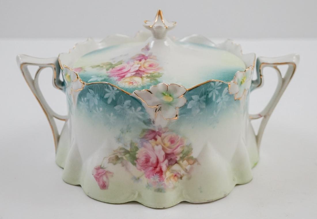 R.S. Prussia Style Biscuit Jar: R.S. Prussia style or unmarked biscuit jar. Has one chip on the outside edge. Measures 5.25" x 9". We ship most items from this auction in house and gladly combine shipping.