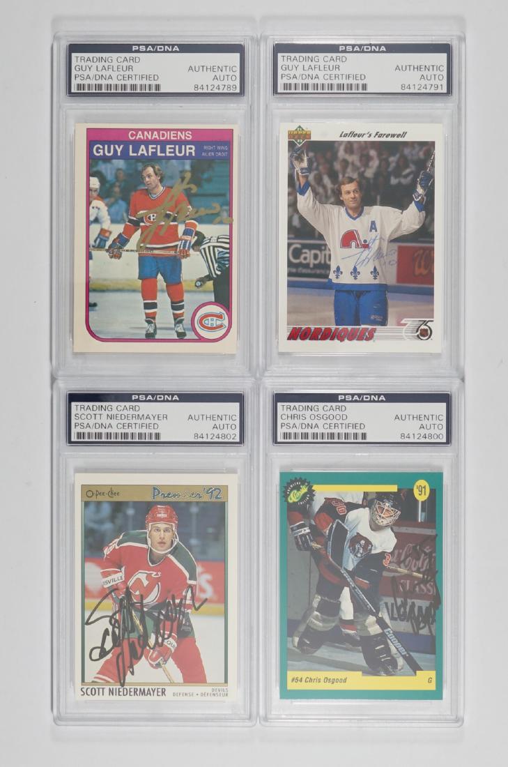 Four Signed Hockey Cards with Guy Lafleur: Four signed hockey cards. All four are PSA/DNA authenticated and encapsulated. Includes Guy Lafleur (2), Chris Osgood and Scott Niedermayer. We ship all items from this auction in-house and gladly com