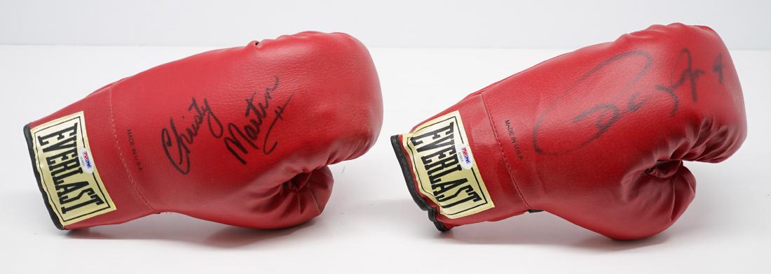 Roy Jones, Jr. & Christy Martin Boxing Gloves: Roy Jones, Jr. and Christy Martin signed boxing gloves. Both include PSA/DNA COA's #AE99521 and #AE99520. We ship all items from this auction in-house and gladly combine shipping if possible of multip