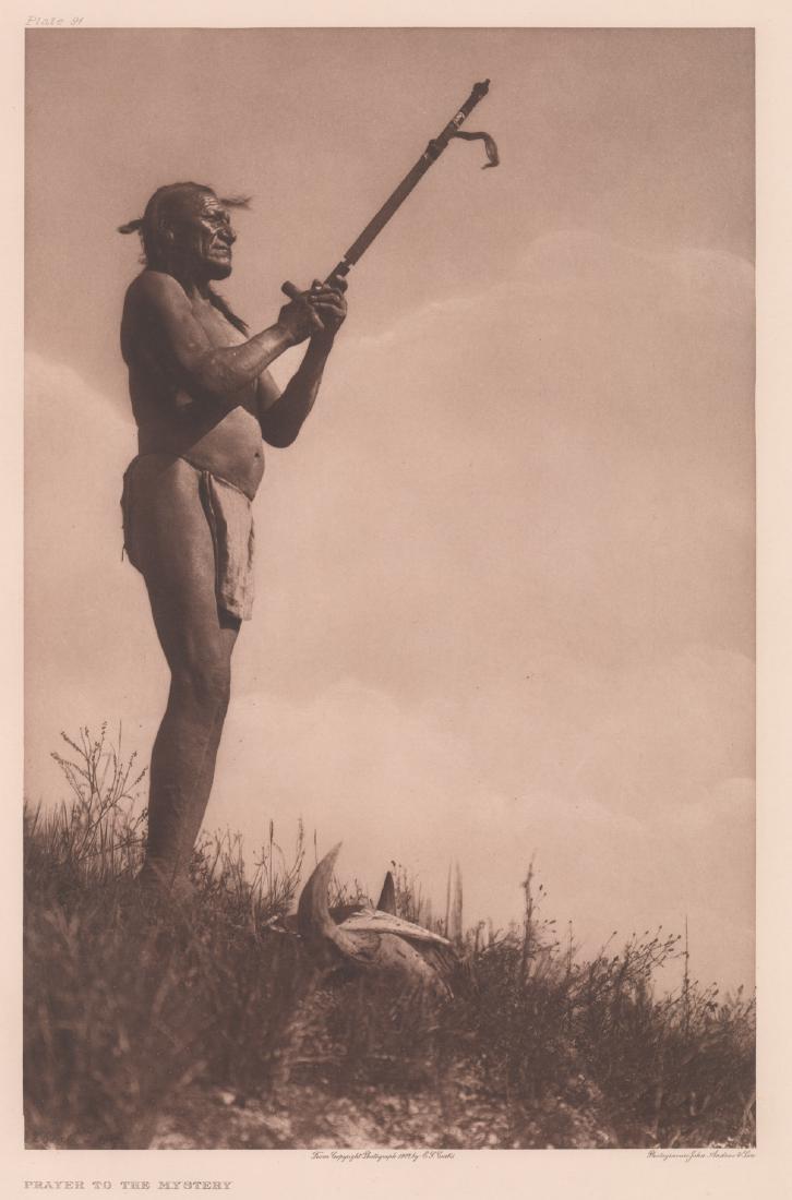 Edward Curtis Photogravure Prayer to the Mystery: Edward Curtis Photogravure titled "Prayer to the Mystery" plate 91. Reads "From Copyright Photograph 1907 E.S. Curtis" below image. Holland Van Gelder Paper watermark in margin. Measures 17.75 in. x 1