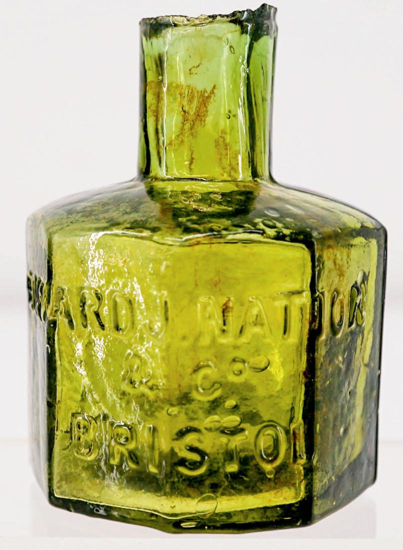 Edward J. Nation Olive Green Ink Bottle: Edward J. Nation & Co. antique olive green ink bottle. Measures 2.875 in. x 2.125 in. Chips on lip. This is an estate lot sold as-is and all sales are final. Condition report is provided as a courtesy