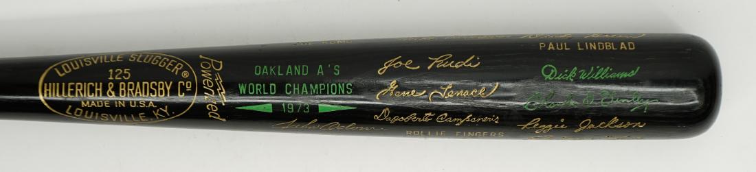 1973 Oakland A's World Series Commemorative Bat: 1973 Oakland A's World Series Commemorative baseball bat. Gold and green foil and paint on black bat. Excellent condition with a few ball marks from light use. 34.75 inches. Condition report is provid
