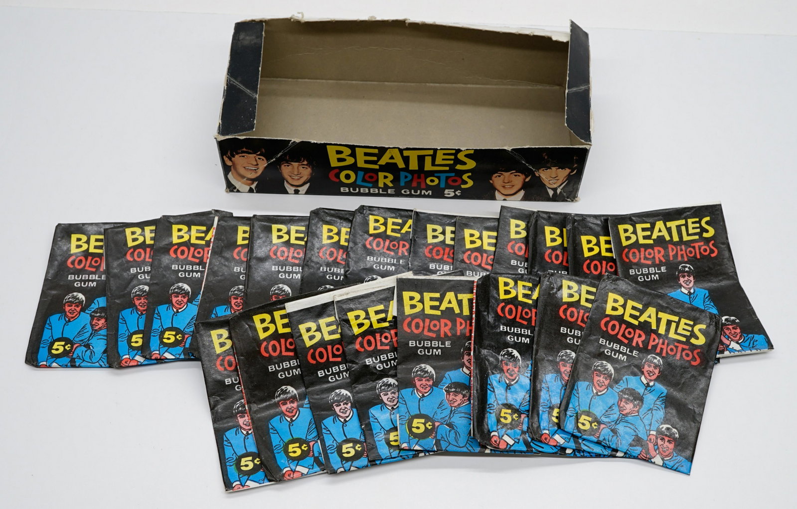 Beatles Topps Color Photos Wax Box and Wrappers: Vintage Beatles Topps Color Photos wax box (no lid) and (21) wax pack wrappers only. If lot is absent of a condition report a condition report may be requested via email. Condition report is provided 