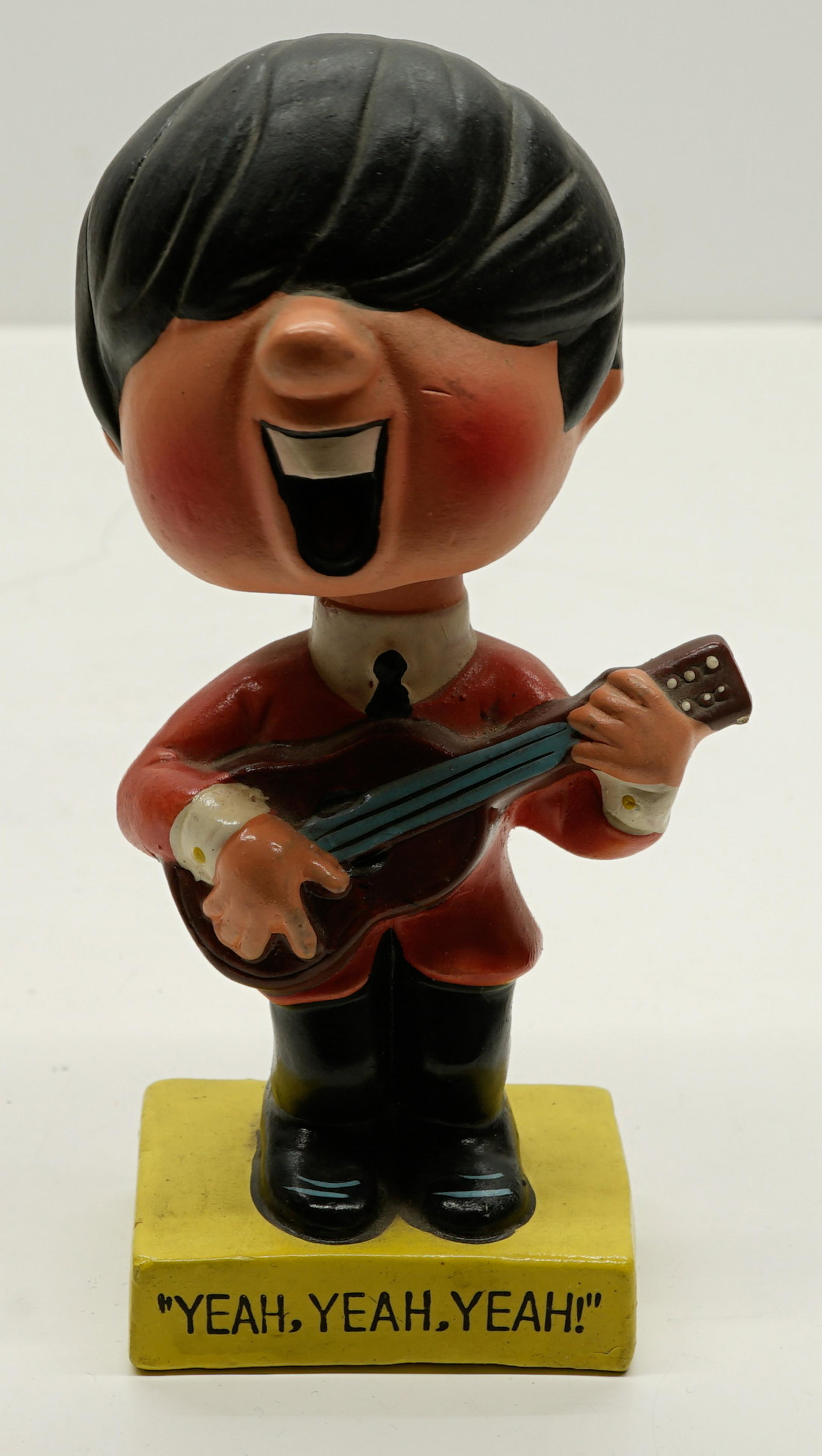 Beatles Generic Nodder: Beatles generic nodder. Measures 6 in. tall. This composition nodder has to hairline cracks to the head. If lot is absent of a condition report a condition report may be requested via email. Condition