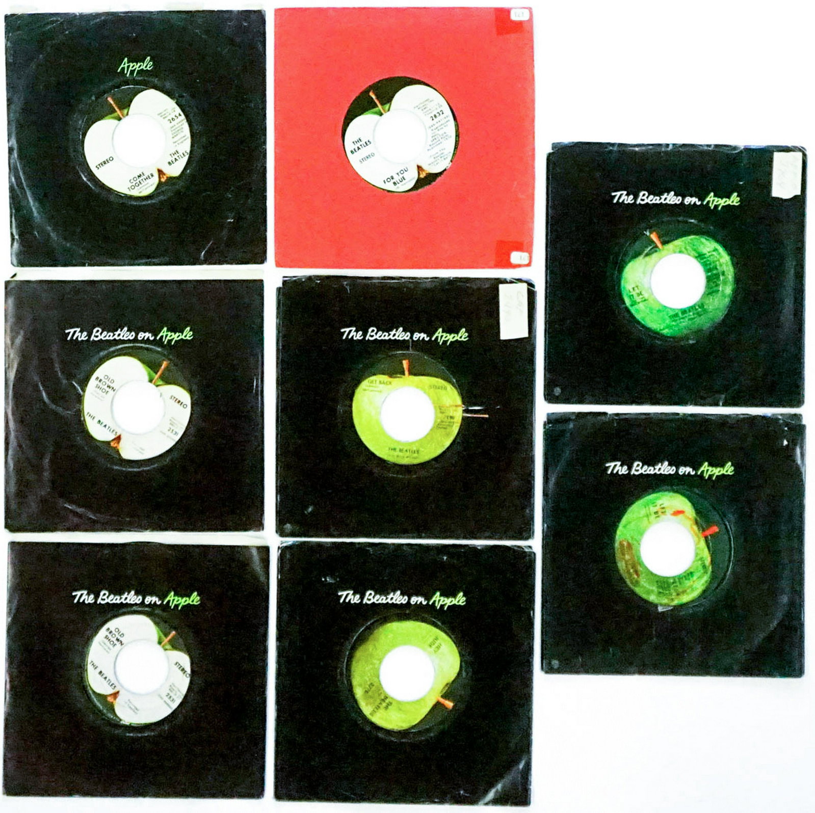 The Beatles on Apple (8) 45 RPM Records: The Beatles on Apple group of eight 45 RPM records. Includes: 1) Two 'Let It Be' 2764 with 'You Know My Name' 2) 'Hey Jude' 2276 with 'Revolution' 3) 'Get Back' 2490 with 'Don't Let Me Down' 4) 'Somet