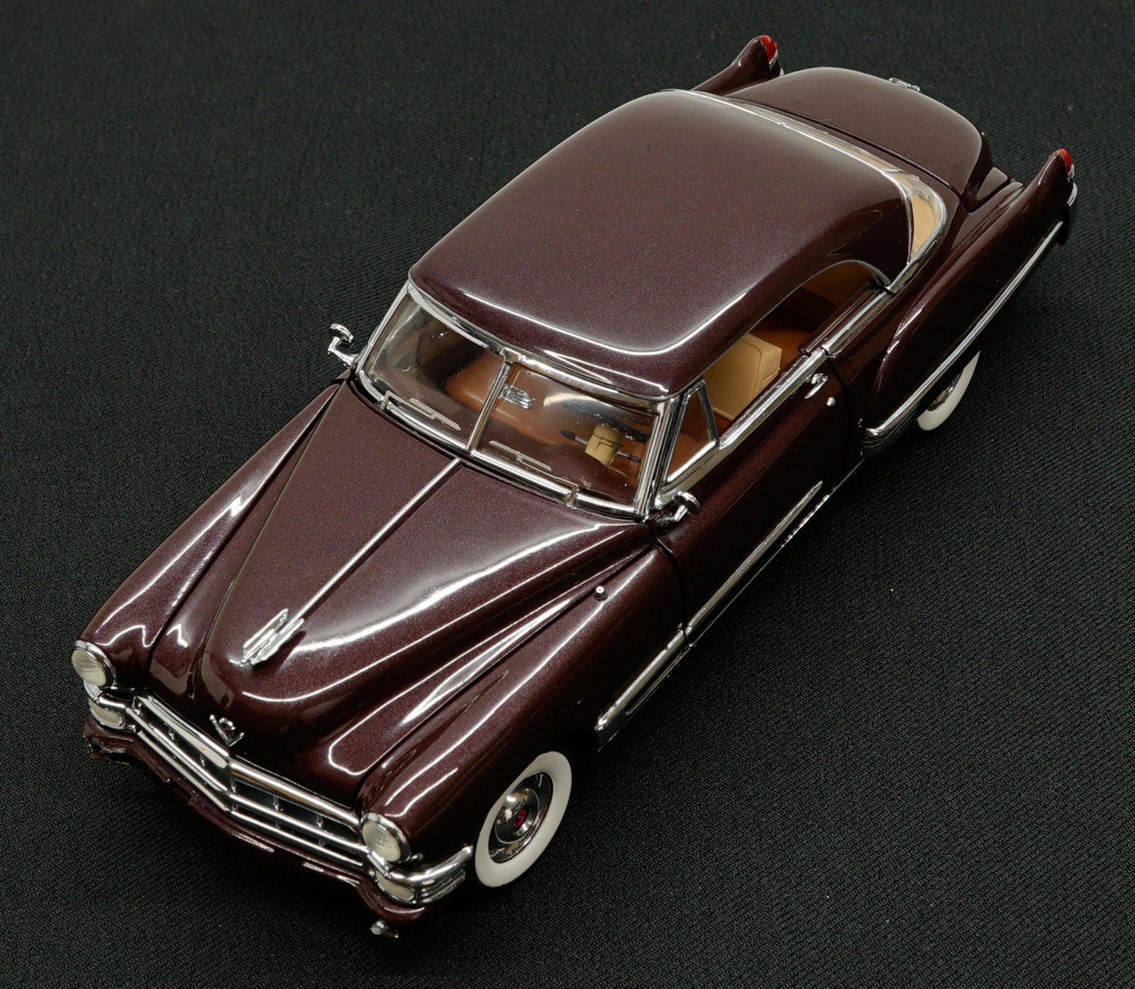 1949 Cadillac Coupe DeVille MIB: 1949 Cadillac Coupe DeVille 1:24 scale model car. Mint in box with papers. Provenance: Private Collection Missoula, Montana. If lot is absent of a condition report a condition report may be requested 
