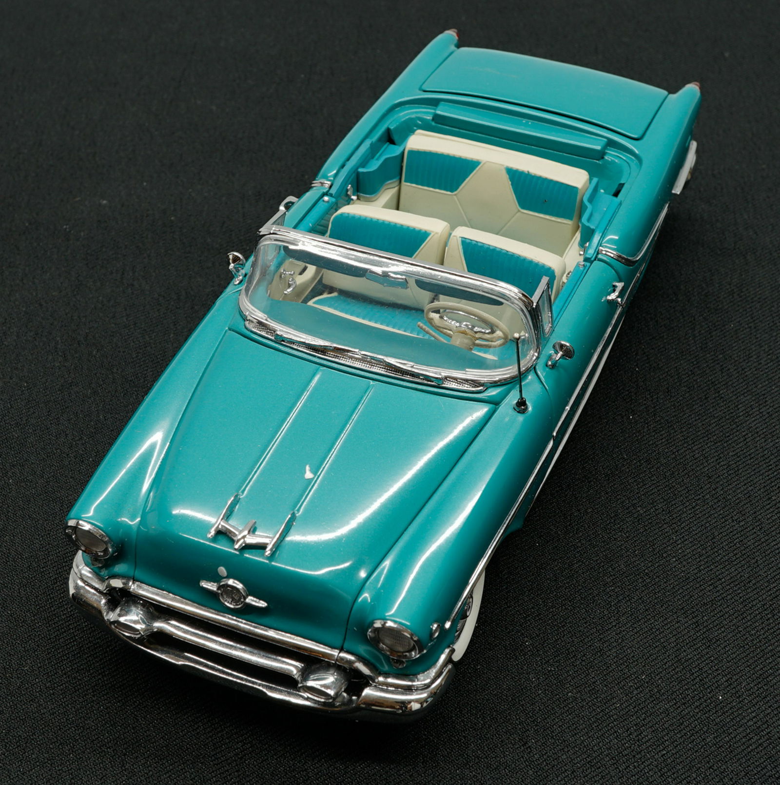1955 Oldsmobile Super 88 Limited Edition MIB: 1955 Oldsmobile Super 88 Limited Edition 1:24 scale model car. Mint in box with papers. The Danbury Mint. Provenance: Private Collection Missoula, Montana. If lot is absent of a condition report a con