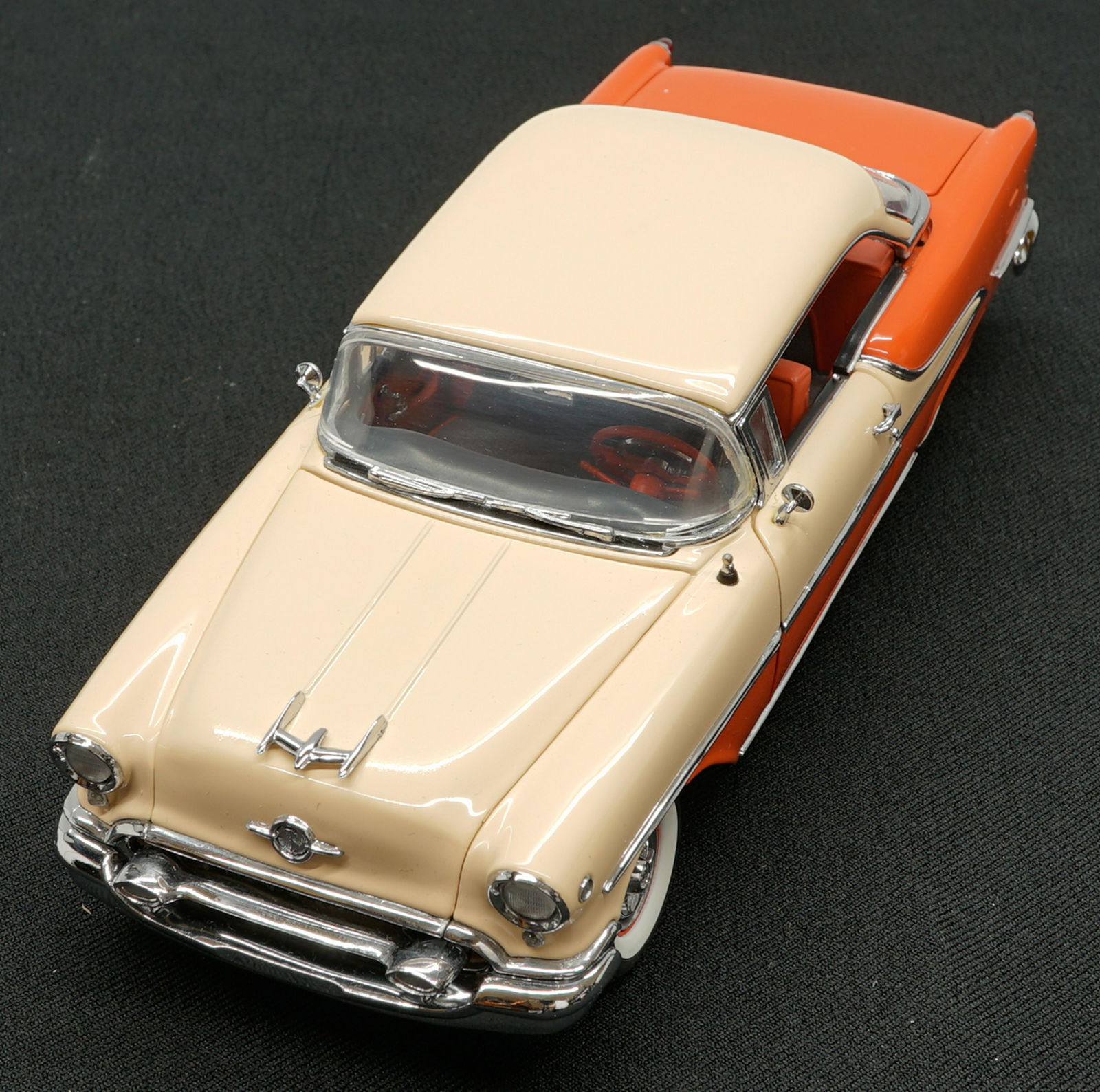 1955 Oldsmobile Holiday Coupe Limited Edition MIB: 1955 Oldsmobile Holiday Coupe Limited Edition 1:24 scale model car. Mint in box with papers. The Danbury Mint. Provenance: Private Collection Missoula, Montana. If lot is absent of a condition report