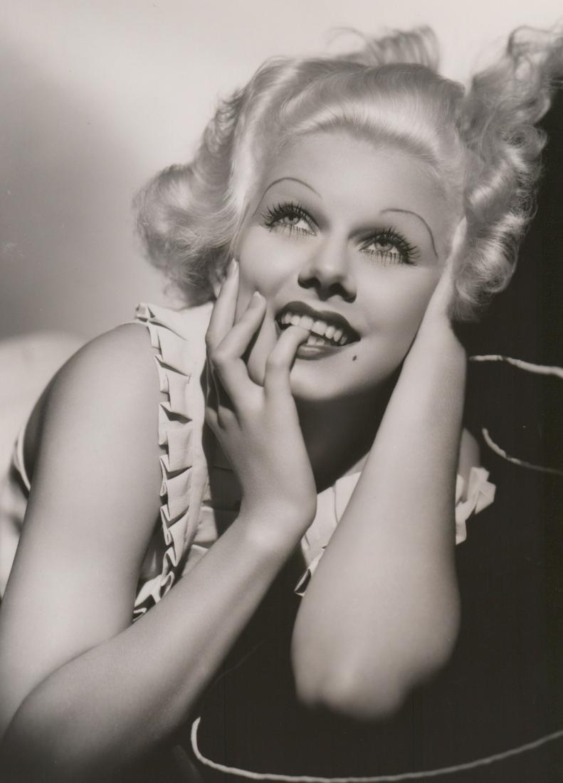 Jean Harlow Photographed by George Hurrell: Jean Harlow in 'Bombshell' (MGM, 1933) oversized publicity still. Photographed by George Hurrell with photographers rubber stamp verso. Semi-glossy surface, double-weight black and white gelatin silve