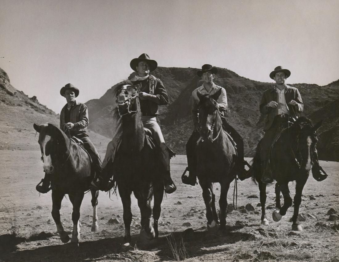 Sons of Katie Elder Oversized Production Still: John Wayne in Sons of Katie Elder (Paramount, 1965) oversized production movie still. Semi-Glossy surface, double-weight black and white gelatin silver print. Measures approximately 11 in. x 14 in. VG