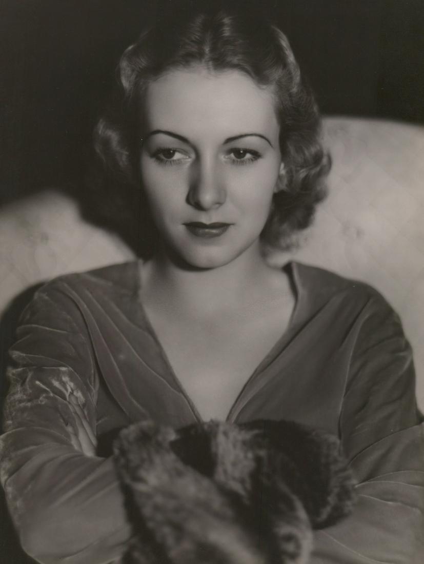 Karen Morley Photographed by George Hurrell: Karen Morley circa 1930's oversized publicity photograph. Photographed by George Hurrell with photographers rubber stamp verso. Semi-glossy surface, double-weight black and white gelatin silver print.