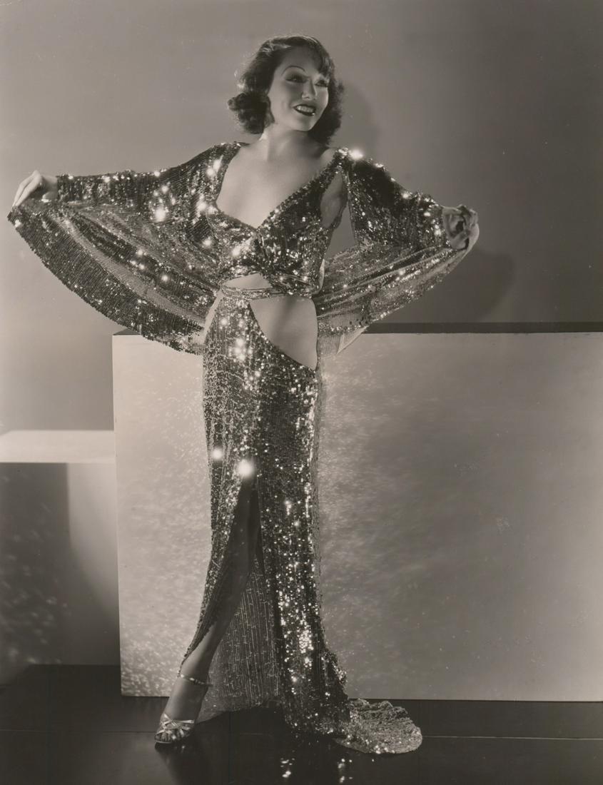 Lupe Velez Photographed by C.S. Bull: Lupe Velez in 'Hollywood Party' (MGM, 1934) oversized publicity photograph. Photographed by Clarence Sinclair Bull with photographers rubber stamp verso. Semi-glossy surface, double-weight black and w