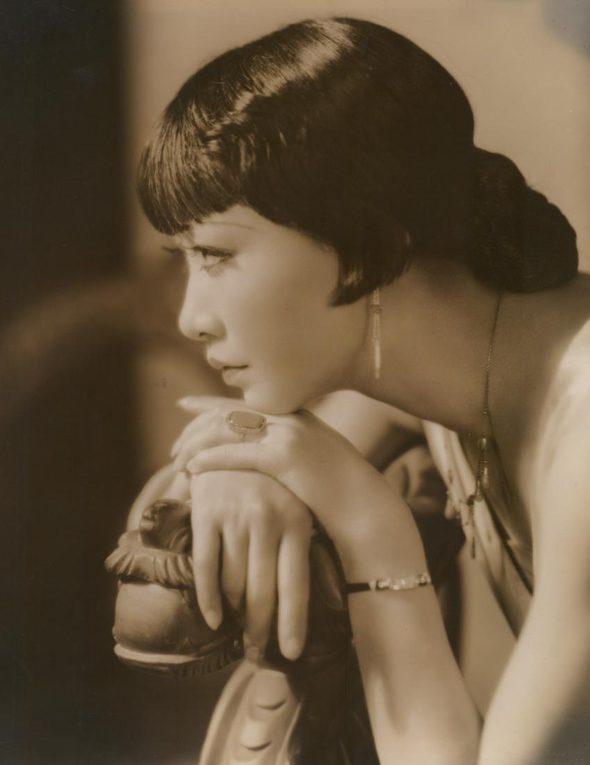 Anna May Wong Photographed by Eugene Richee: Anna May Wong in 'On The Spot' oversized publicity photograph circa 1930's. Photographed by Eugene Robert Richee with photographers rubber stamp verso and blind stamp lower right. Glossy surface, doub