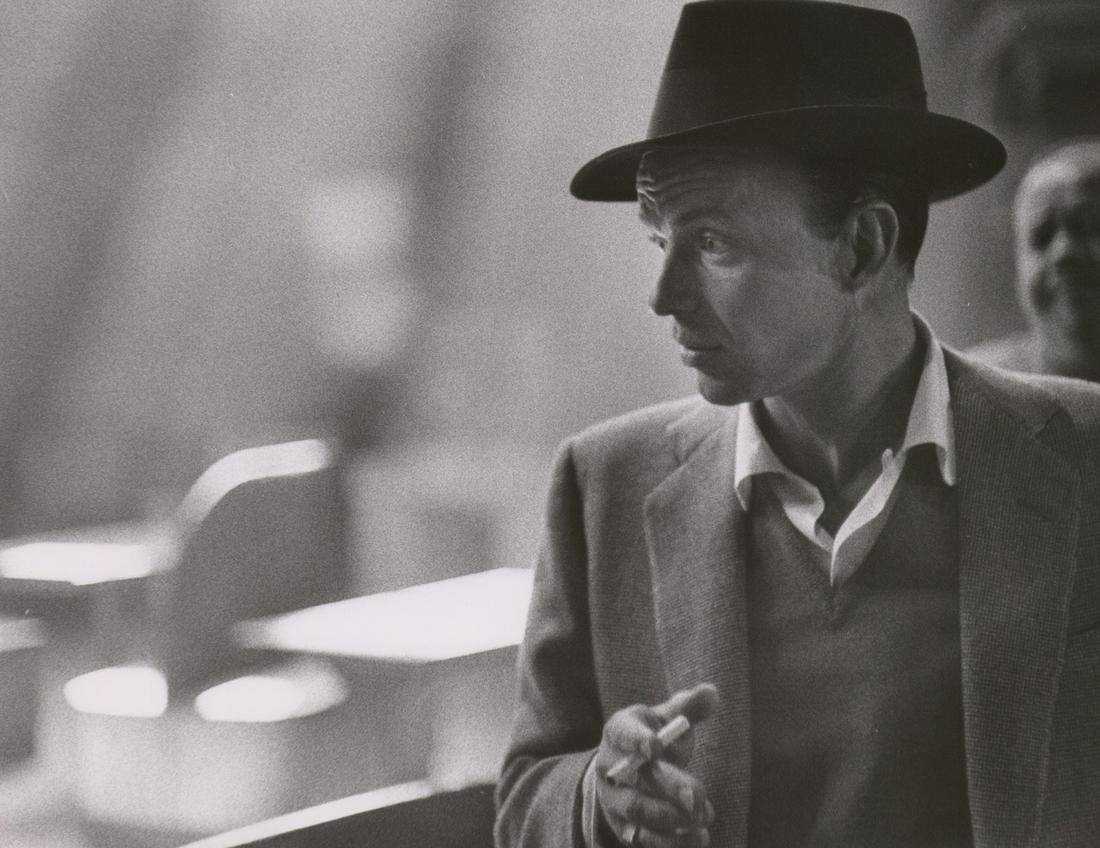 Frank Sinatra Photographed by Phil Stern: Frank Sinatra production still photographed by Phil Stern. An oversized production photograph signed by photographer verso. Stamped 'Phil Stern' with rubber stamp verso. Semi-glossy surface, double-we