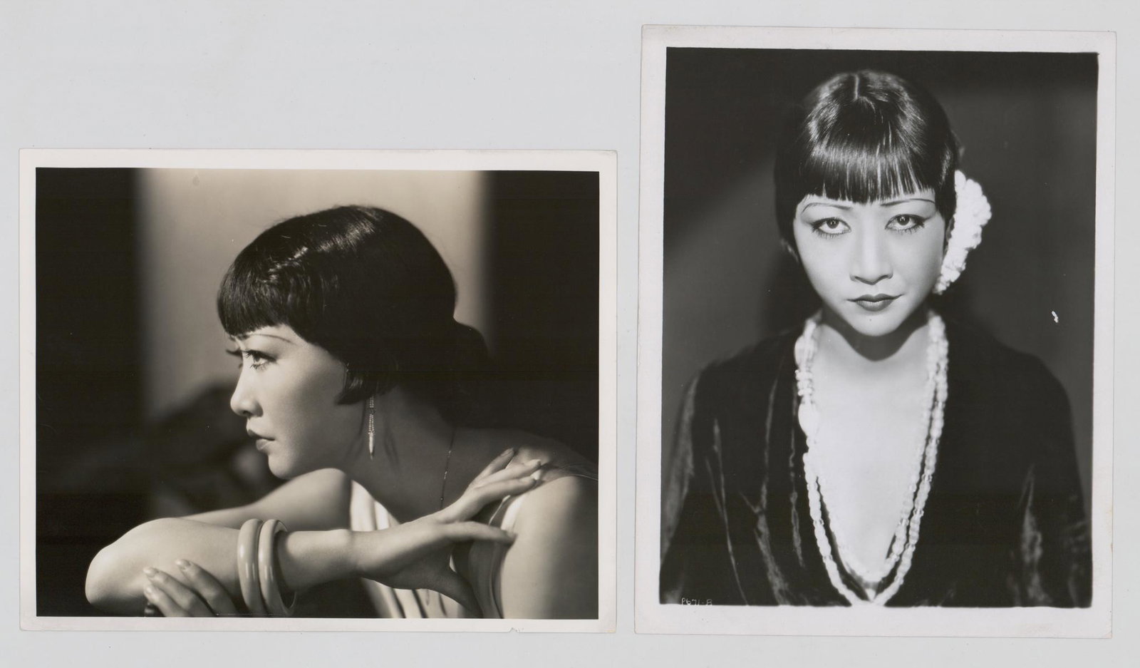 Anna May Wong Vintage Publicity Photos (2): Two Anna May Wong vintage publicity still photos. One is stamped by Photographer Eugene Robert Richee verso. Both are glossy surface black and white photographs measuring approximately 10 in. x 8 in. 