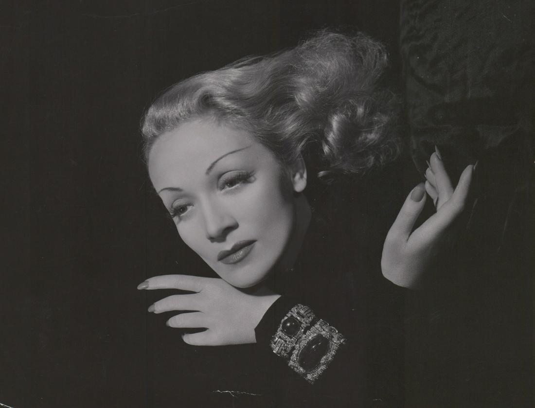 Marlene Dietrich Photographed by C.S. Bull: Marlene Dietrich in Kismet (1944) vintage oversized publicity photo. Photographed by Clarence Sinclair Bull with photographers rubber stamp verso. Semi-glossy surface, double-weight black and white ph