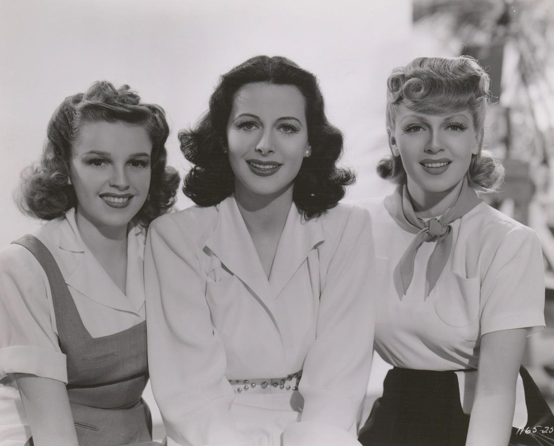 Judy Garland, Hedy Lamarr and Lana Turner (1941): Judy Garland, Hedy Lamarr and Lana Turner photographed by Clarence Sinclair Bull. This photo is dated February 14, 1941 with rubber stamp verso. Glossy, single-weight black and white gelatin silver pr