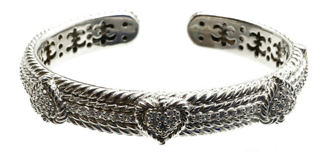 Judith Ripka Sterling Cuff Bracelet: Judith Ripka sterling cuff bracelet. Signed and stamped '925'. Measures .4375 inches in width and 2.8125 inches across. Weighs 44 grams. If lot is absent of a condition report a condition report may b