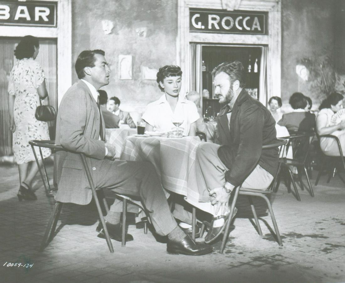 Gregory Peck, Roman Holiday 1953 Photo: Gregory Peck, Audrey Hepburn and Eddie Albert in 'Roman Holiday' (Paramount, 1953) vintage production photo. Black and white single-weight glossy surface. Measures 8 in. x 9.75 in. Provenance: Formerl