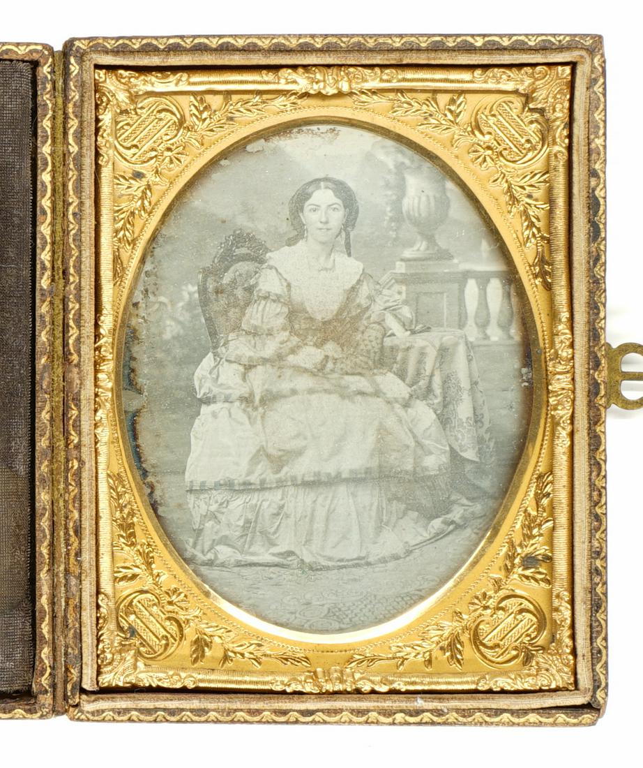 Woman in Fancy Dress Ambrotype Quarter Plate: Woman in fancy dress quarter plate ambrotype. Total size is 3.625 in. x 4.75 in. Provenance: Mark Rucker collection. If lot is absent of a condition report a condition report may be requested via emai