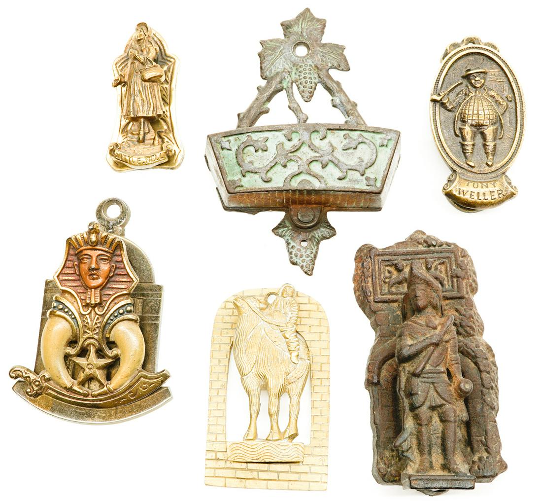 Six Antique Door Knockers and Metal Ware: A group with four metal door knockers, one Shriner's clip and one match holder. If lot is absent of a condition report a condition report may be requested via email. Condition report is provided as an