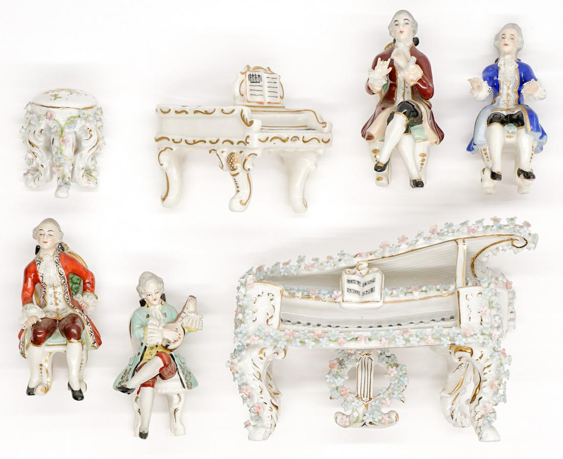 A Group of Porcelain and Lace Pianos and Musicians: A group of porcelain and lace pianos and musicians. Largest piano measures 4 in. x 5 in. and musicians measure 3.25 in. No apparent damage. Buyer must view photographs or scans to assist in determinin