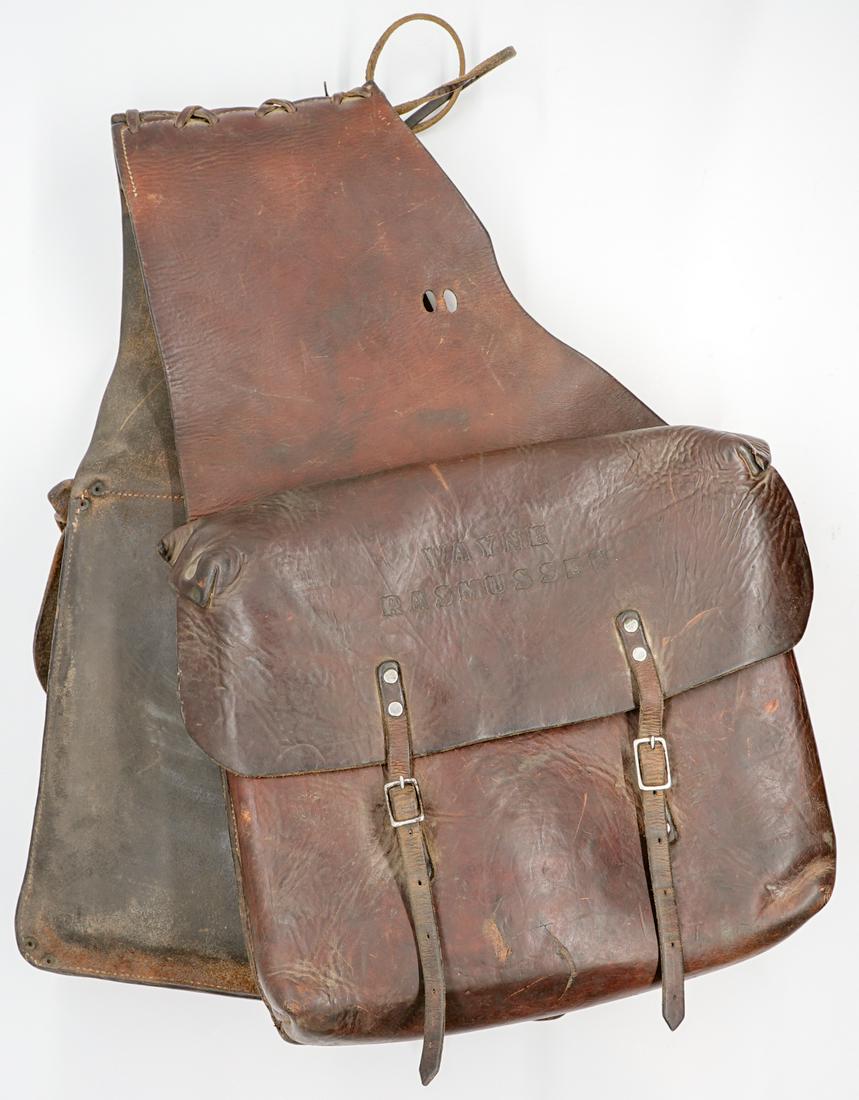 An Old West Saddle Bags: An Old West leather saddle bags. Measures 22.5 in. x 15 in. Good condition. Buyer must view photographs or scans to assist in determining condition and ask further questions if so desired. We ship mos