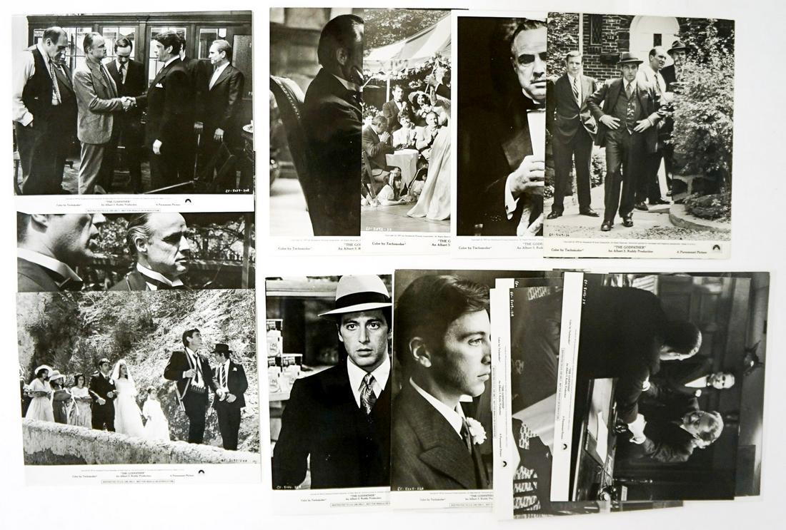 The Godfather Publicity (24) Photos: Group of twenty-four publicity photos of 'The Godfather' (Paramount 1972). Al Pacino, Marlon Brando, James Caan, and others. Glossy black and white single-weight. Measure approximately 10 in x 8 in. a